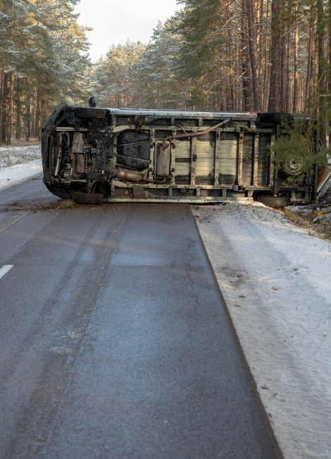 A-road-accident-of-a-delivery-vehicle-on-an-icy-road-in-the-forest.-Season-winter