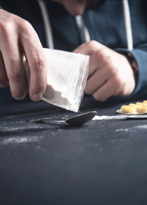 Man-with-a-packet-of-heroin.-Drug-addiction-concept