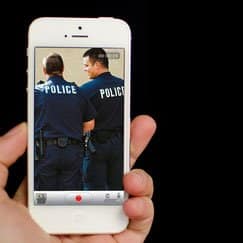 recording the police | Varghese Summersett Person recording police on their cell phone